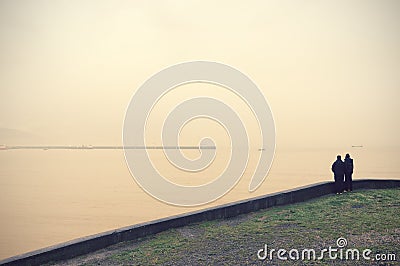 Two people looking sea with vintage filter effect Stock Photo