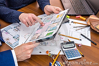 Two people talking about architectural project with engineering tools on workplace. Stock Photo