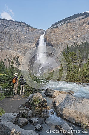 Two People View Takakkaw Falls Editorial Stock Photo