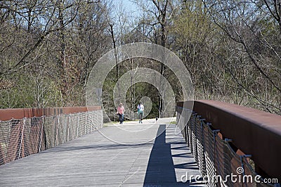 Two People walk a dog over the Wolf River bridge. Editorial Stock Photo