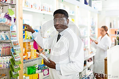 Pharmacists putting drug packages in order Stock Photo