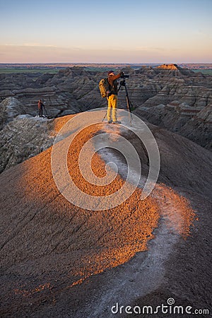 Two photographers photograph White River Valley Overlook at Badlands National Park during a sunrise Editorial Stock Photo