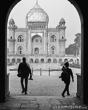 Two photography student walking with camera trough the main gate,entrance of safdarjung tomb memorial at winter morning black and Editorial Stock Photo