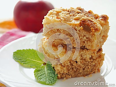 Two pieces of coffeecake on white plate. Fresh crumble pie with streusel topping and mint leaf. Stock Photo