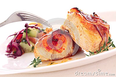 Two pieces of roast chiken with bacon and salad Stock Photo