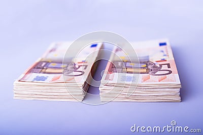 Two piles of fifty euros Stock Photo