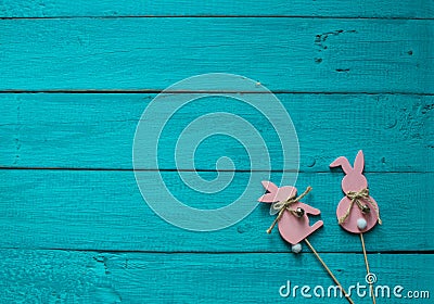 Two pink Easter bunnys on a blue wooden background Stock Photo