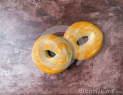 Two plain bagels on a red mottled countertop top view Stock Photo