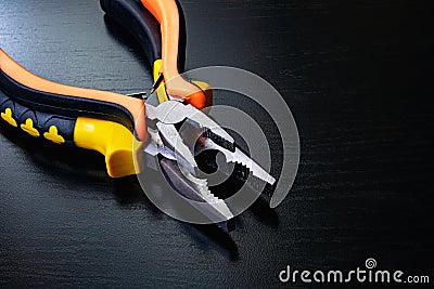 Two pliers, tools on a wooden table Stock Photo