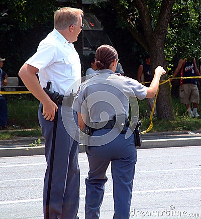 Two police officers discuss evidence at a crime scenein Hyattsville, Maryland Editorial Stock Photo