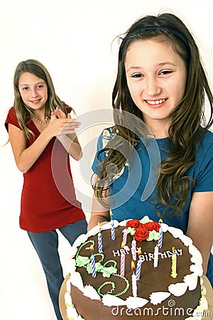 Two preteens with birthday cake Stock Photo