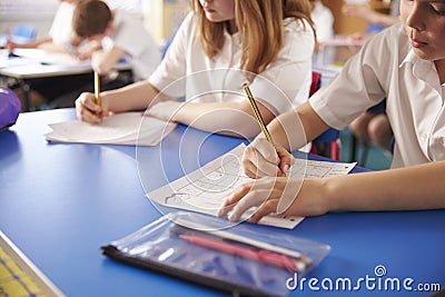 Two primary school kids working in class, close crop Stock Photo