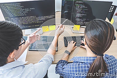 Two professional programmers cooperating at Developing programming and website working in a software develop company office, writ Stock Photo