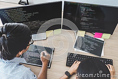 Two professional programmers cooperating at Developing programming and website working in a software develop company office, writ Stock Photo