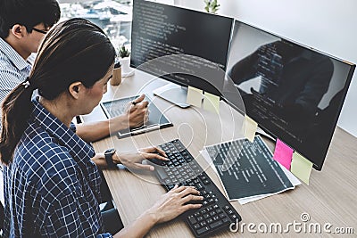 Two professional programmers cooperating at Developing programming and website working in a software develop company office, writ Stock Photo