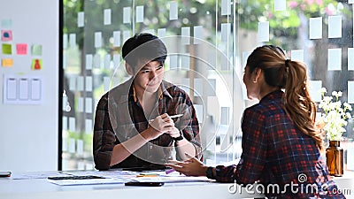Two web developers brainstorming and working together for mobile application software design project. Stock Photo