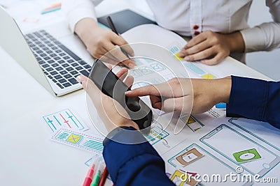 Two programmer test coding technologies with mobile phone for comparing mobile and desktop website. User experience concept Stock Photo