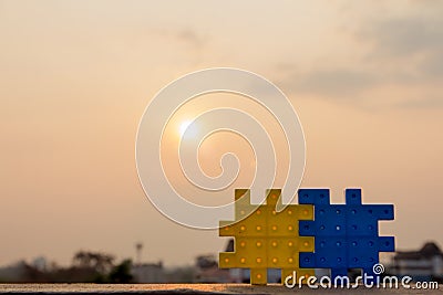 Two the puzzle pieces along with the sun background up,Teamwor Stock Photo