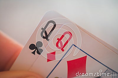 Two queens, Playing cards in hand on the table, poker nands Stock Photo