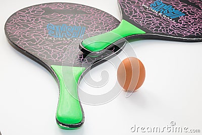 Two rackets and an egg on a white background. Editorial Stock Photo