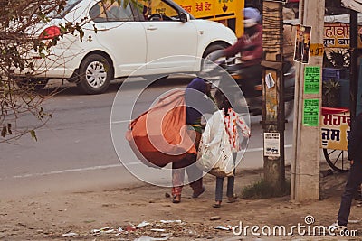 Two rag pickers with bags moving on the street Editorial Stock Photo