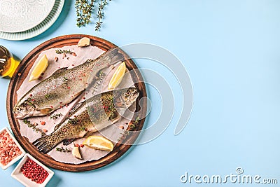 Two raw rainbow trouts on paper with thyme and lemon. Fish trout. Top view. Free space for your text Stock Photo