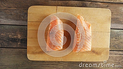 Two raw salmon fillets on wooden cutting board Stock Photo