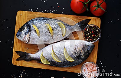 Two ready to cook fresh dorada fish Stock Photo