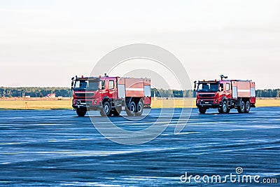 Two red airfield fire trucks at the airport Stock Photo