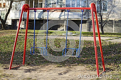 two red and blue swings Stock Photo