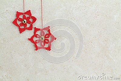 Two red crochet christmas stars on sponged background Stock Photo