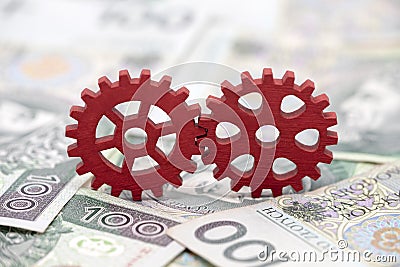 Two red gears on polish money Stock Photo