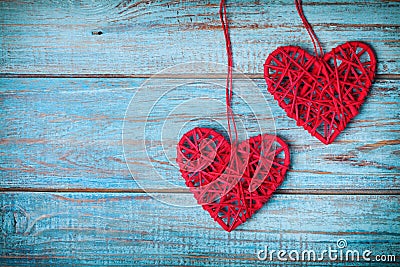 Two red heart hanging on turquoise vintage wall for Valentines day card Stock Photo