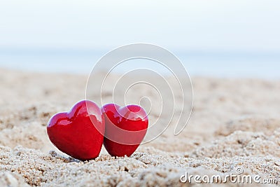 Two red hearts on the beach. Love Stock Photo