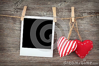 Two red hearts and blank instant photo Stock Photo