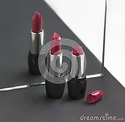 Two red lipsticks, perfect versus imperfect symbolic concept ide Stock Photo