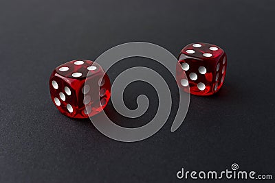 Two red playing dices on black table. Luck and fortune concept Stock Photo