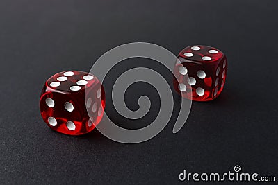 Two red playing dices on black table. Luck and fortune concept Stock Photo