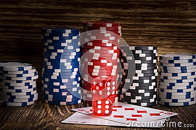 Two red poker cube lie on the cards against the background of poker chips Stock Photo