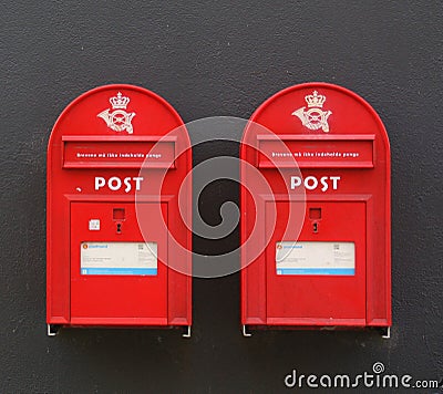 Two red postbox. Denmark a black wall. Denmark Editorial Stock Photo