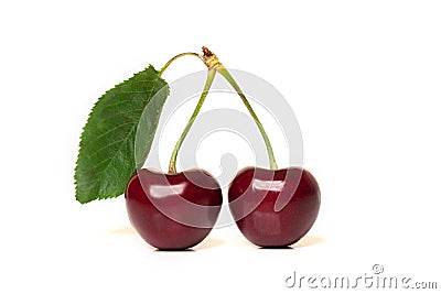 Two red ripe cherries with stems and a leaf on white background Stock Photo