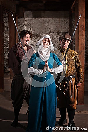 Swordsmen Teasing Nun Stock Photo