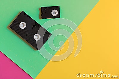 Two retro videocassette on three-color paper background. Flat lay image, minimal concept Stock Photo