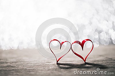 Two ribbon hearts on wood Stock Photo