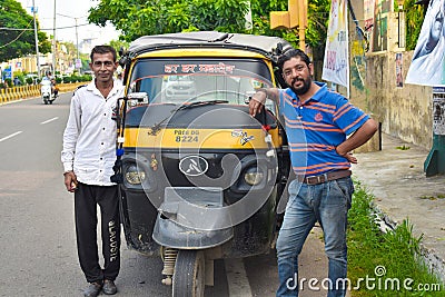 Two rickshaw driver smile with their auto Editorial Stock Photo