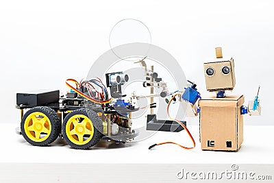 Two robots stand on the table. Robot holds servo and prop Stock Photo