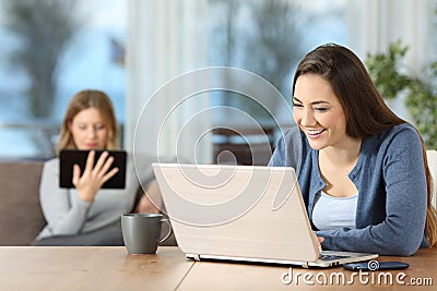 Roommates using multiple wifi devices at home Stock Photo