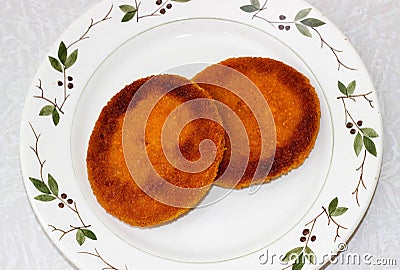 Two round fried Burger patties on a plate Stock Photo