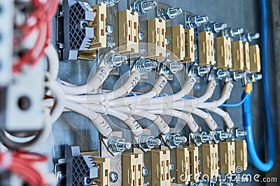 Two rows of bolt terminal blocks, connected to it by electrical wires or cables. Stock Photo