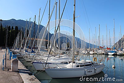 Two rows of sailboats, dock at Lake Riva, Italy Editorial Stock Photo
